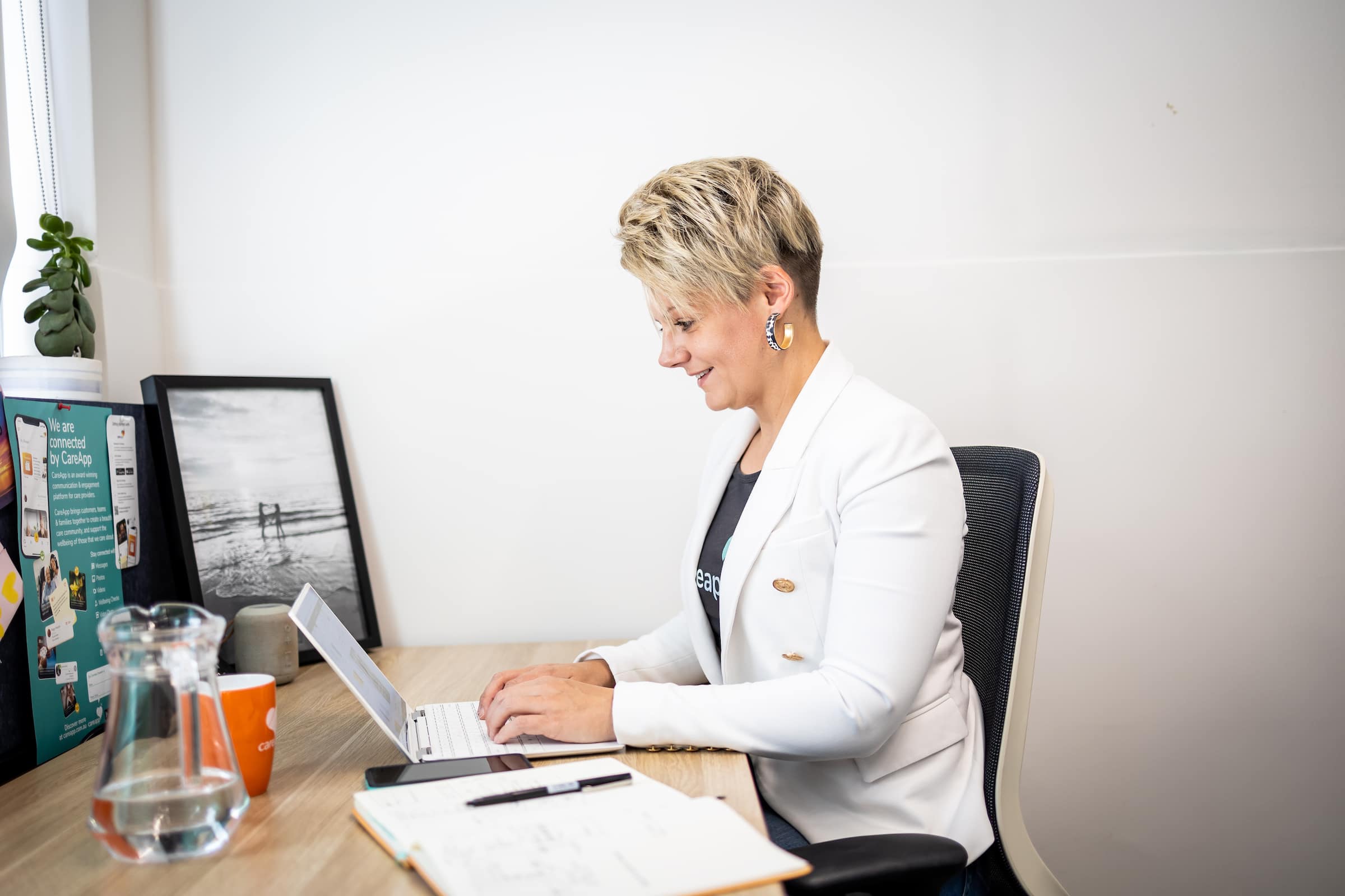 A hospital employee sitting at their desk with their laptop using Xero accounting software.