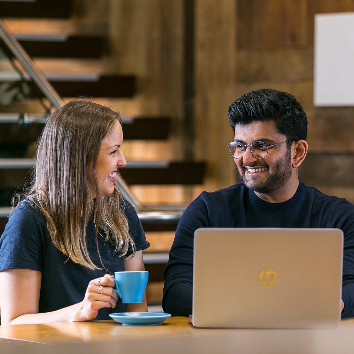 Man and women collaborating while drinking coffee.