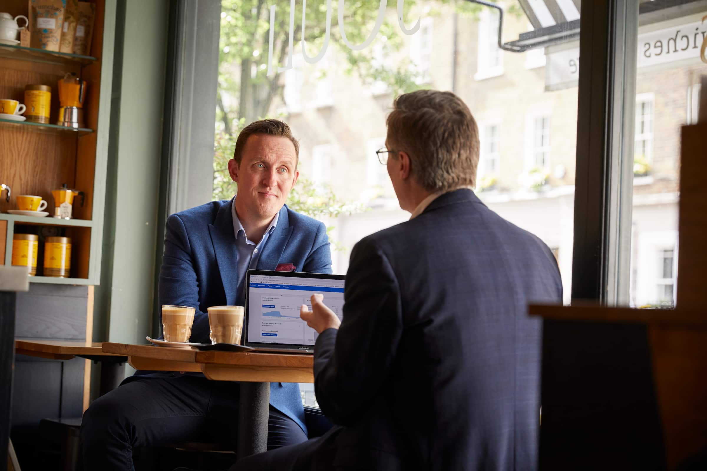 A consultant meeting with a client and using Xero accounting software on their laptop.