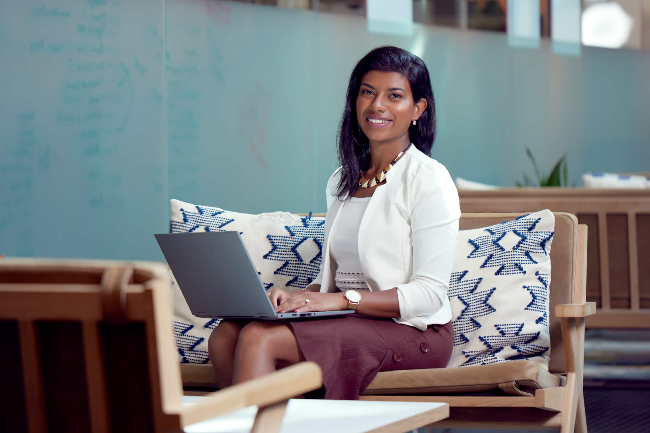 A nonprofit owner sitting on a couch with their laptop using Xero budgeting software.