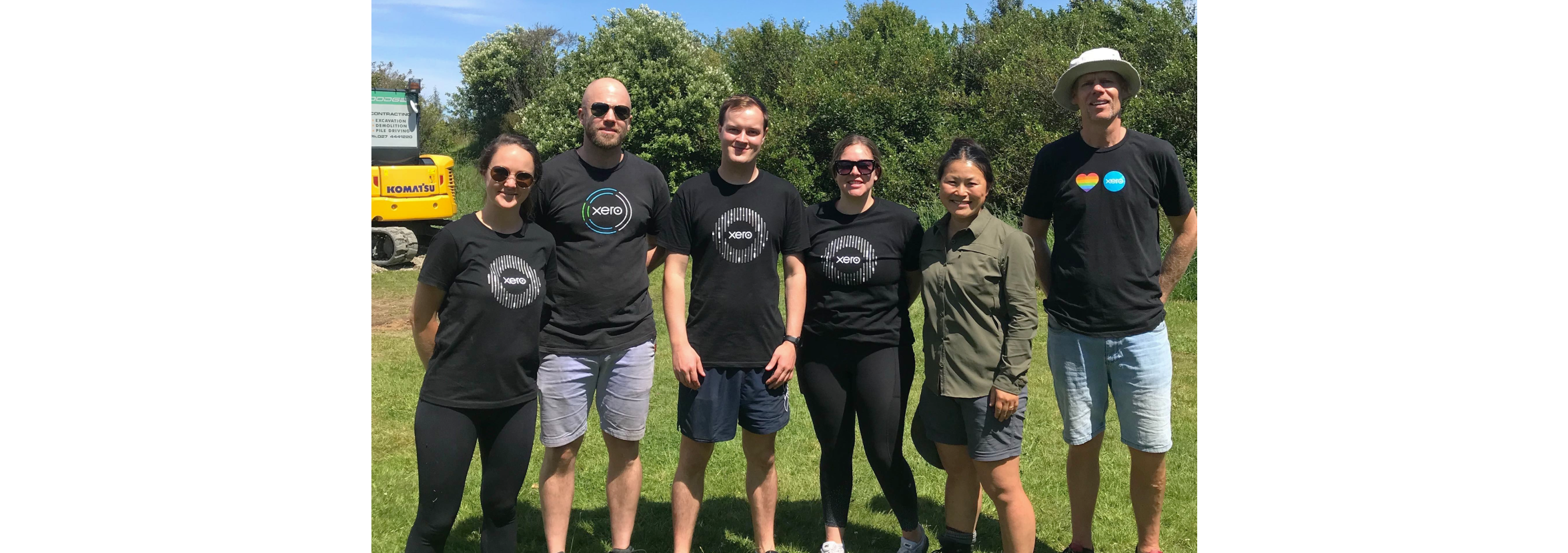 A group of Xero staff members on a volunteer day, standing outside.